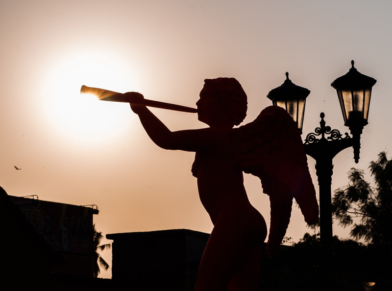 silhouettes, sunset, musical instrument, real people, sculpture, 2K, buildings, beautiful, cherub, hat, playing, lifestyles, arts culture and entertainment