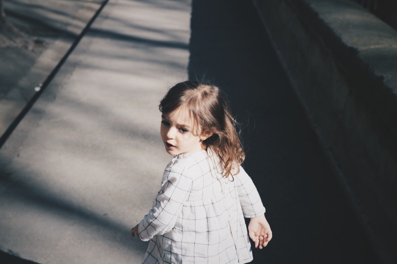 focus on foreground, childhood, wearing, waist up, leisure activity, walking, casual clothing, running, teenager, children Only, concrete, 8K, jacket