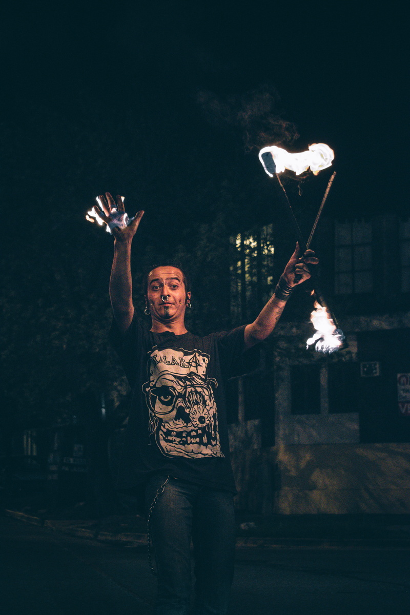 arms raised, lifestyles, argentina, front view, fire, leisure activity, calle, urban, human arm, juggle, women, casual clothing, three quarter length, night