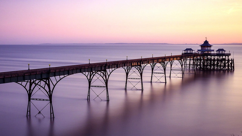 bridge - man made structure, architecture, tourism, sky, nature, beach, outdoors, horizon, land, pier, water, purple landscape, beauty in nature, sea, travel