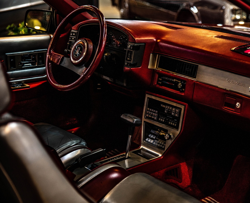 gearshift, vehicle interior, gauge, wheel, no people, spoke, person, retro styled, antique, control panel, hand, transportation, red, car, steering wheel
