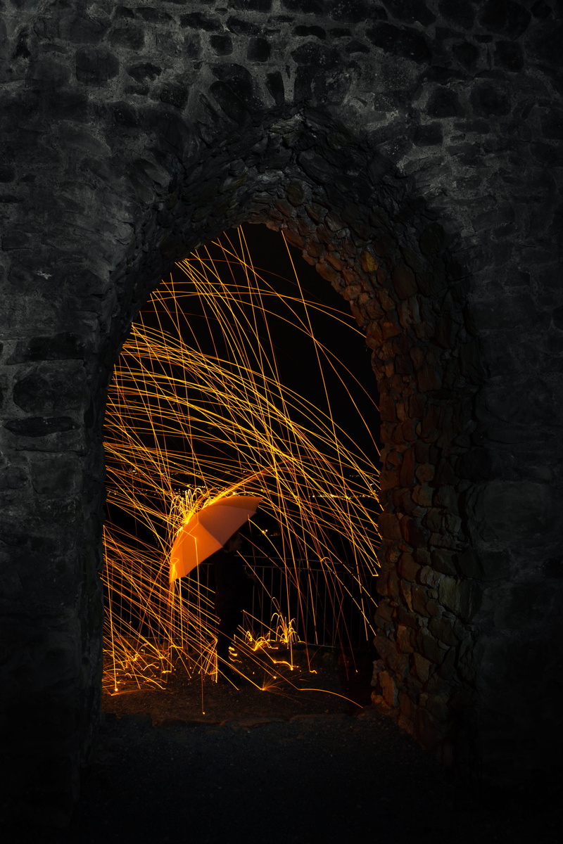 contrast, tail, indoors, standing, person, yellow, heat - temperature, photography, no people, motion, long exposure, stone wall, spark, door, arc, black