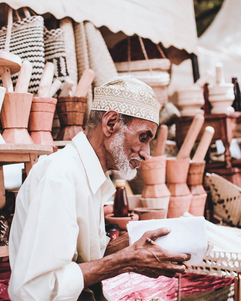 man, clothing, craft, vendor, holding, table, handmade, beard, sales, art and craft, 2K, elderly, mid adult, occupation, handicraft, focus on foreground