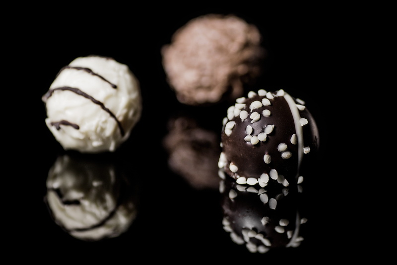 two, nibble, dessert, close, confiserie, praline, no people, black background, round chocolates, truffle, chocolate confectionery, group of objects, datailaufnahme
