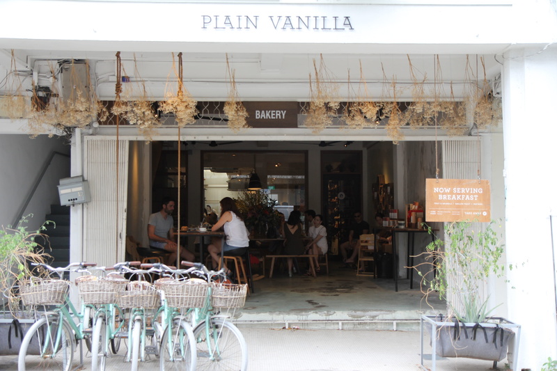 person, group of people, communication, transportation, real people, patio, food court, furniture, vehicle, men, bakeries, western script, sitting, machine