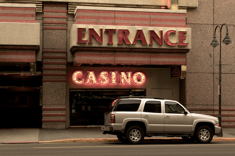 motor vehicle, tire, dish, building exterior, street, western script, communication, silver, beside, no people, transportation, land vehicle, spoke, casino