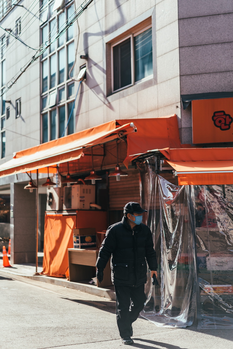 canopy, building, person, three quarter length, day, architecture, orange color, clothing, meal, building exterior, shop, urban, neighborhood, street, kiosk
