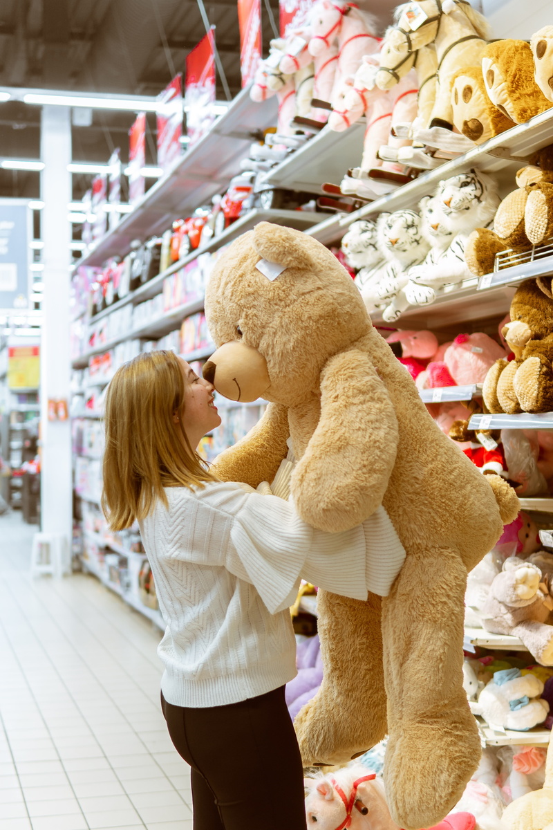 carrying, holding, indoors, bakery, shelf, 5K, supermarket, lifestyles, baby, store, one person, face, blonde hair, life, person, childhood, grocery store
