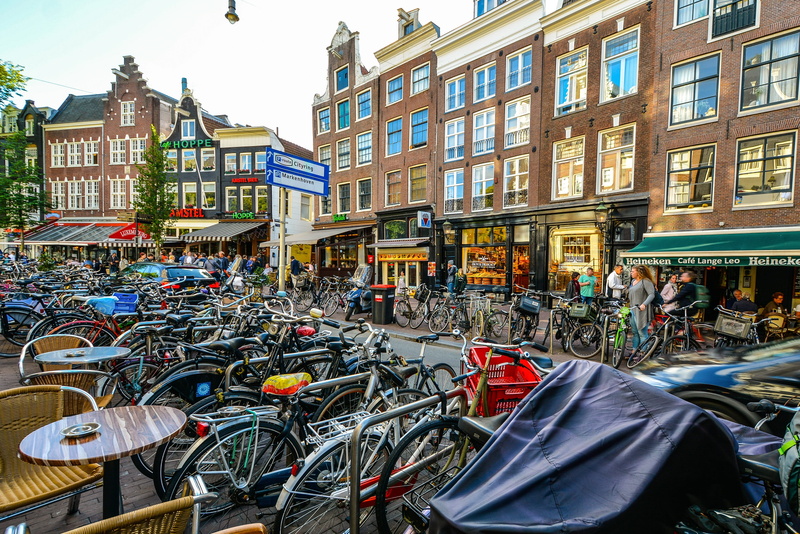 canal, city, window, 2K, tourism, bikes, mode of transportation, heineken, downtown, day, large group of people, city life, street, shops, building, bicycles