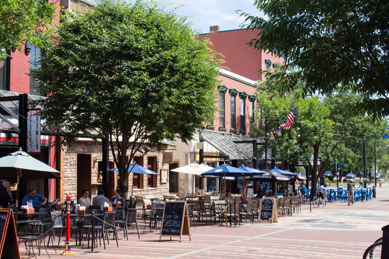 restaurant, outdoors, sidewalk cafe, built structure, storefront, building exterior, signs, real people, sunlight, seat, united states, nature, architecture