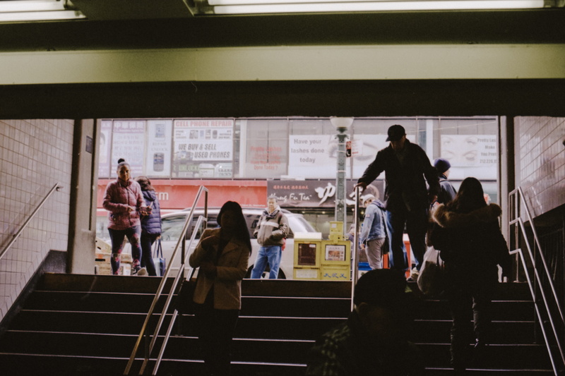 transportation, banister, 8K, apparel, lcd screen, standing, waiting, group of people, clothing, overcoat, monitor, room, human, public transportation