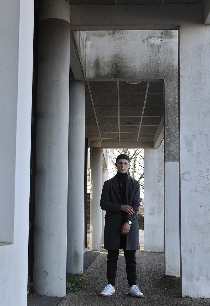 pants, built structure, day, apparel, corridor, 4K, overcoat, concrete, coat, looking at camera, sleeve, flooring, full length, young adult, floor, one person