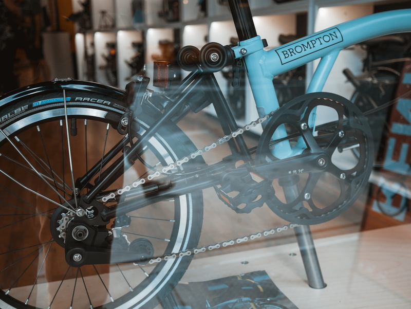 focus on foreground, wheel, transportation, gear, travel, store, teal, indoors, spoke, mode of transportation, close-up, reflection, new york, orange, metal