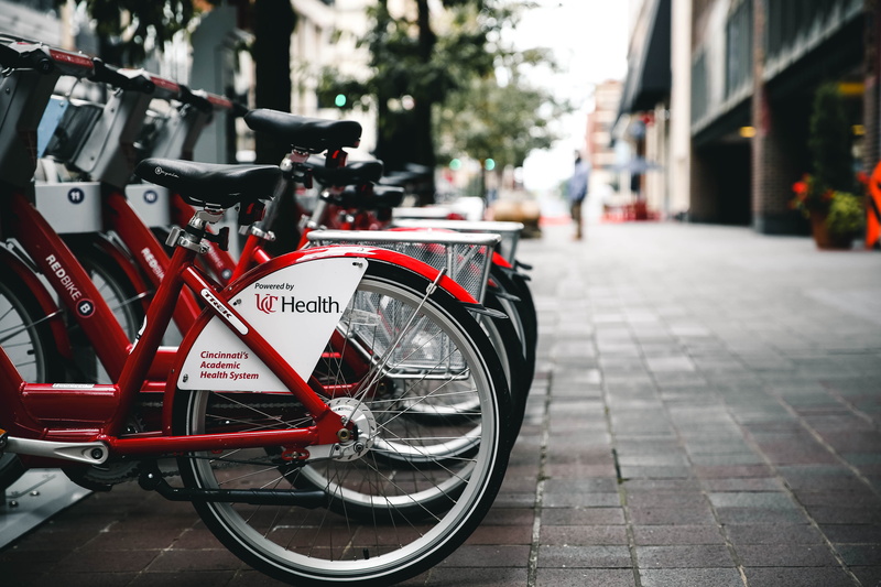 bicycle, day, urban Scene, parking, traffic, outdoors, architecture, incidental people, parked, in a row, building, wheel, cycling, transportation, footpath