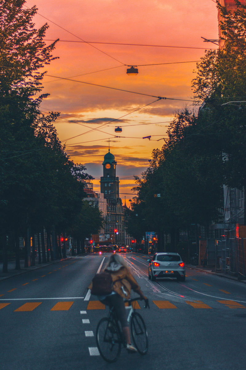 trees, urban, sky, transportation, orange color, riding, building exterior, architecture, mode of transportation, city, cyclist, nature, land vehicle, perspective