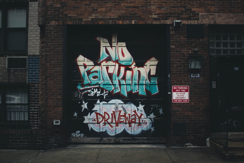 script, sign, architecture, no people, message, building, creativity, garage, wall, building exterior, communication, day, western script, nyc, outdoors