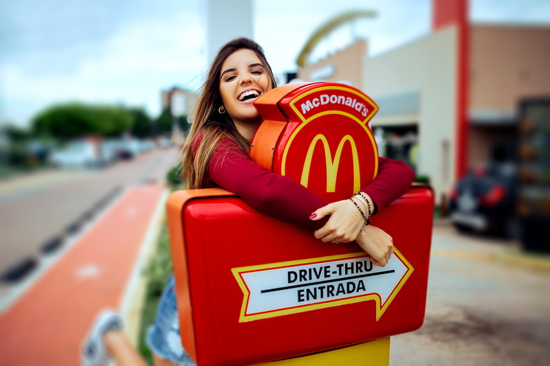 portrait, looking, western script, happiness, women, blur, adult, sign, emotion, one person, smiling, leisure, young adult, leaning, casual, pretty, mcdonalds