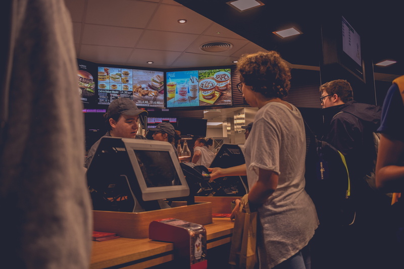 restaurant, working, fastfood, colors, rear view, indoors, standing, neon, sitting, business, food and drink, adult, occupation, women, wireless technology