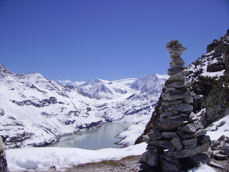 lake, mountain peak, beauty in nature, day, sky, copy space, no people, non-urban scene, mountain range, blue, snowcapped mountain, tranquil scene, nature