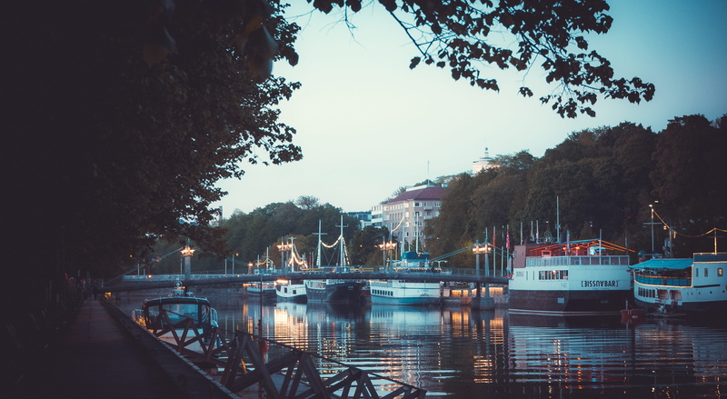 building exterior, no people, night, moored, ships, sailboat, city lights, outdoors, city, boats, clear sky, built structure, nautical vessel, bridge, river