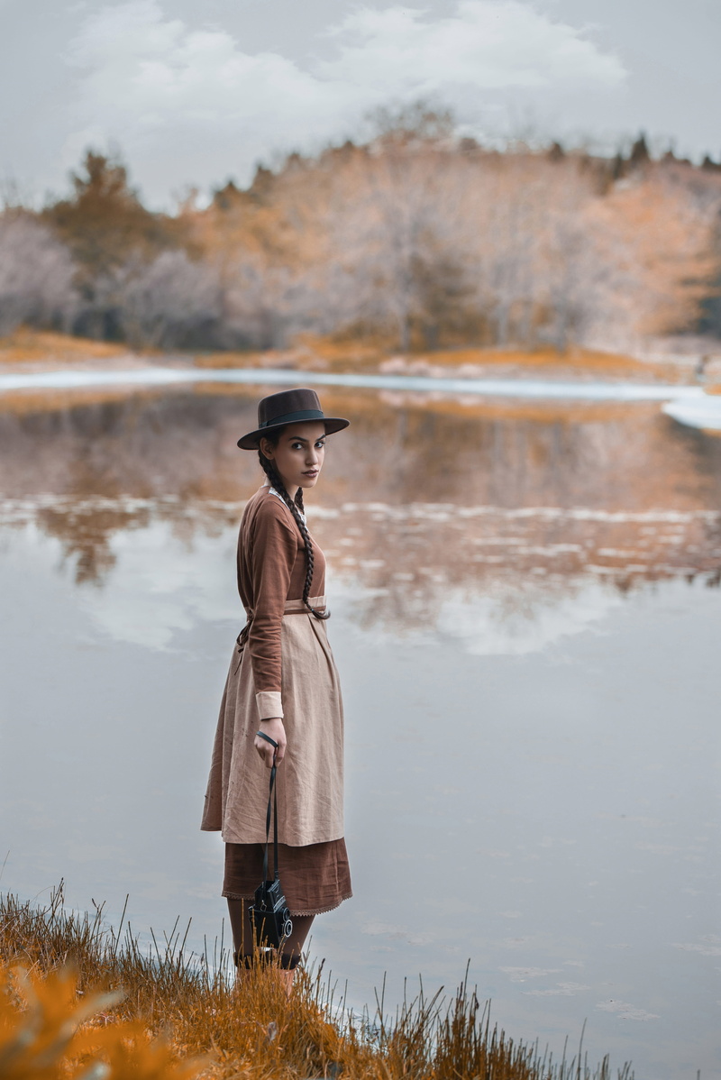 water, side view, lake, daytime, real people, standing, lifestyles, beauty in nature, scenics - nature, clothing, carrying, female, focus on foreground
