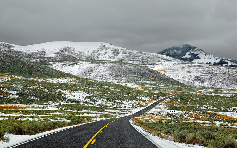 hills, clouds, asphalt, overcast, snow, shrubs, 2K, mountains, sky, field, road