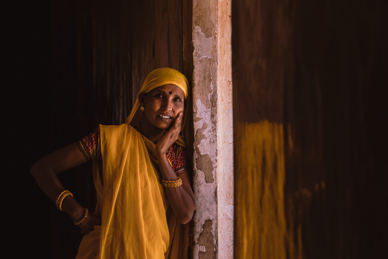 men, indoors, traditional clothing, dress, adult, wall, spirituality, travel, waist up, belief, architecture, traditional, smiling, standing, clothing