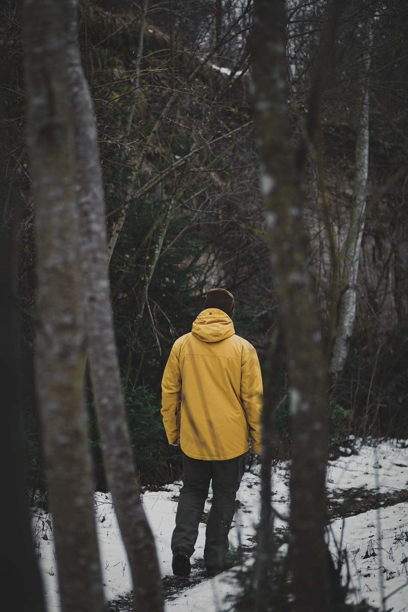real people, winter, snow, tree trunk, trunk, human, gravel, road, yellow, lifestyles, hood, forest, rear view, trees, one person, dirt road, sweatshirt