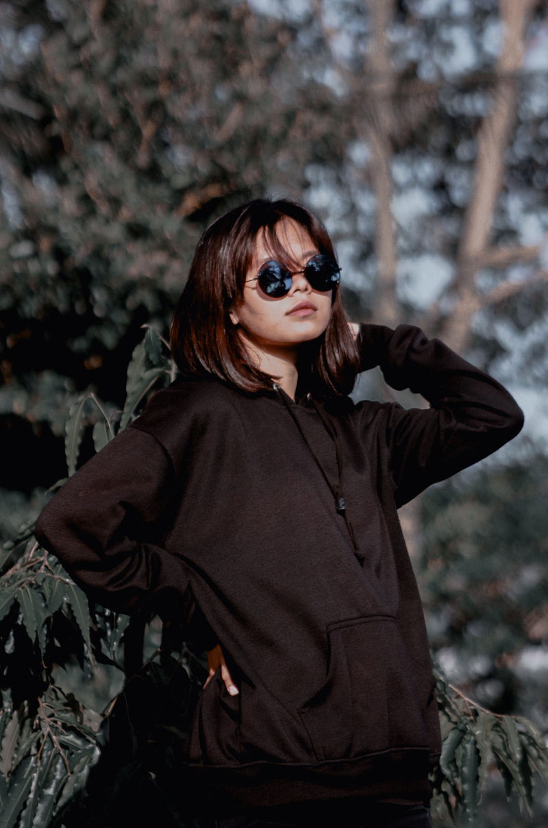 lifestyles, cloak, sweatshirt, hairstyle, real people, one person, leisure activity, glasses, standing, sweater, young women, sunglasses, jacket, clothing