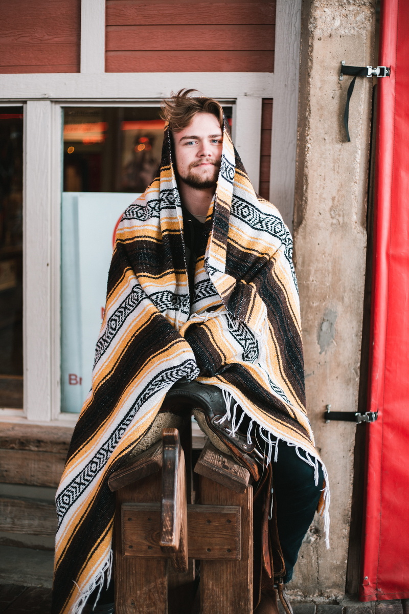 face, lifestyles, smile, poncho, built structure, human, standing, warm clothing, denim, person, leather, three quarter length, model, man, outdoors, one person