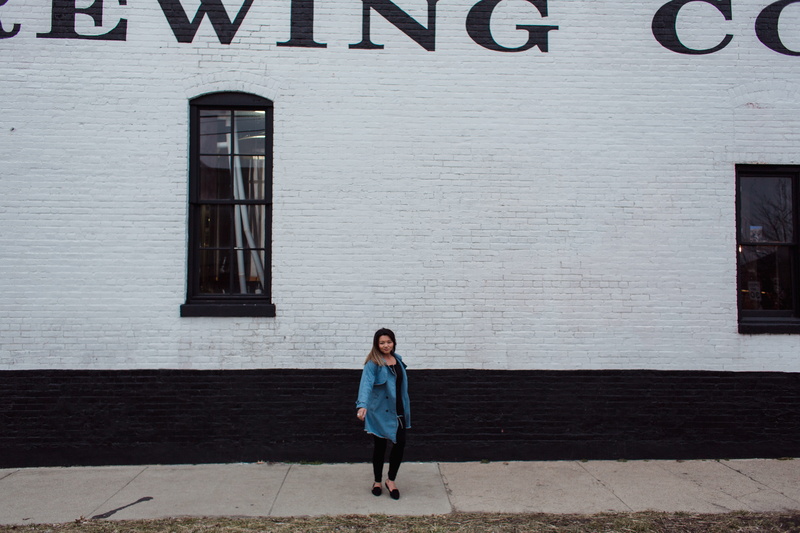 one person, footwear, coat, full length, women, walking, style, building exterior, real people, city, wall - building feature, wall, day, clothing, apparel