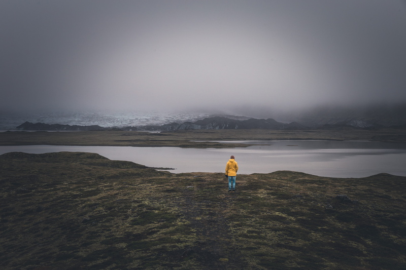 rear view, mountain, water, ice, near, green, motion, adult, yellow, dark, beach, full length, environment, outdoors, sea, nature, tranquility, foggy, great