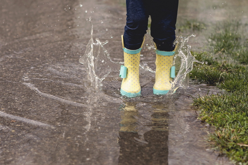 april, real people, jeans, yellow rain boots, apparel, rainy day, rubber boot, human, april showers, jump, person, water, one person, human leg, coat, outdoors