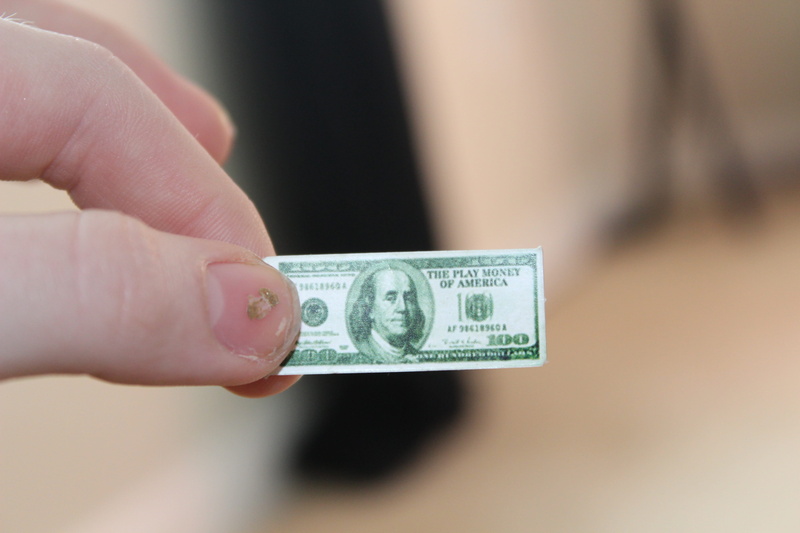 indoors, hand, little, dollar, monopoly, business, body part, economy, wealth, currency, adult, human hand, finance, one person, fake, pretend, finger