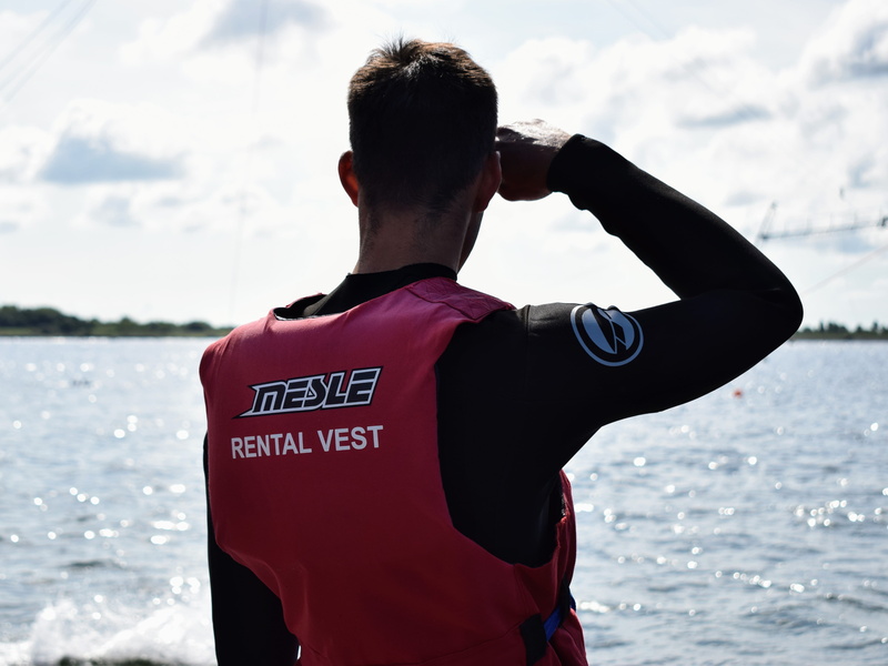 text, lake, sport, sea, man, day, red, standing, lookout, view, real people, rear view, focus on foreground, men, water, clothing, nature, lifejacket, sky