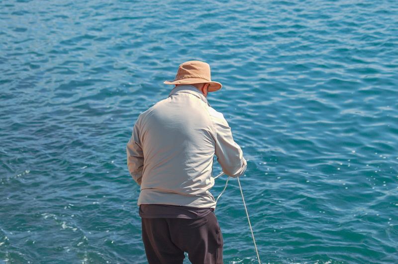 leisure activity, cowboy hat, angler, nature, casual clothing, ocean, lifestyles, senior adult, leisure activities, hat, 2K, person, sun hat, fish, standing
