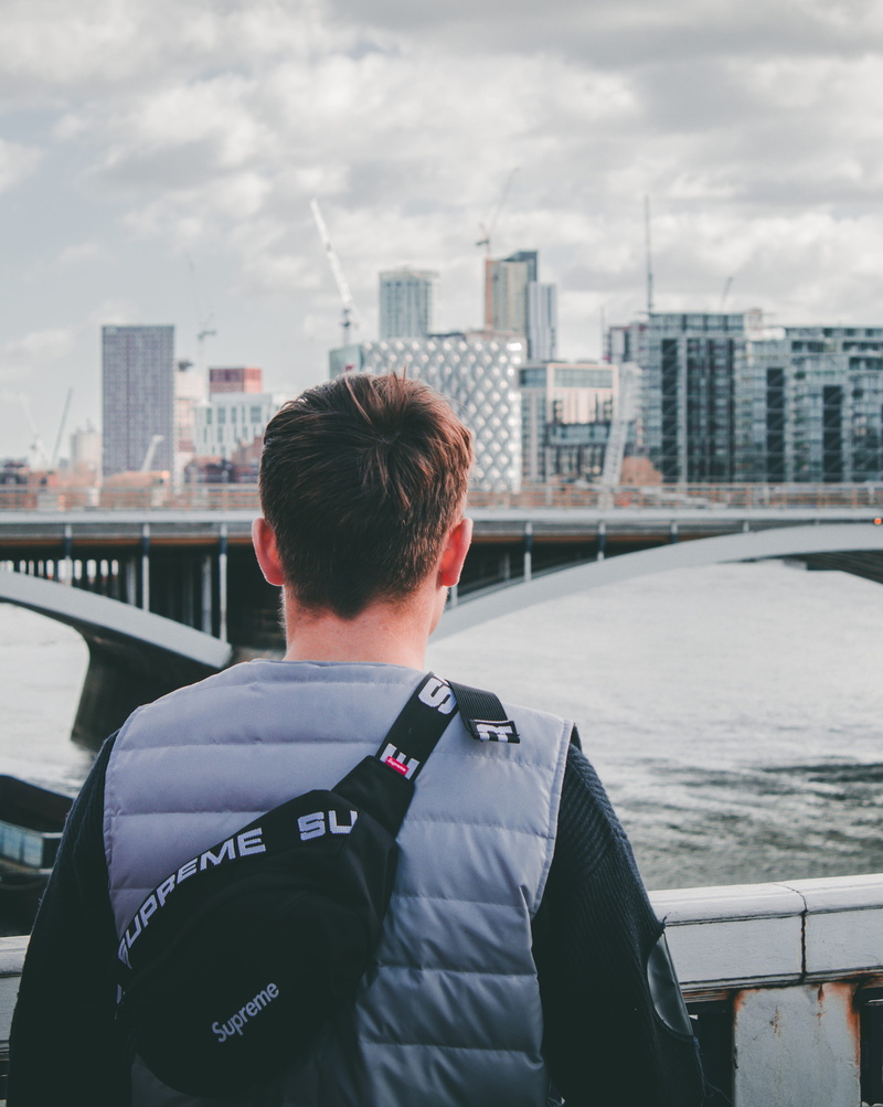 clothing, person, railings, architecture, standing, portrait, back, metropolis, day, real people, headshot, 4K, cityscape, uniform, high rise, nature