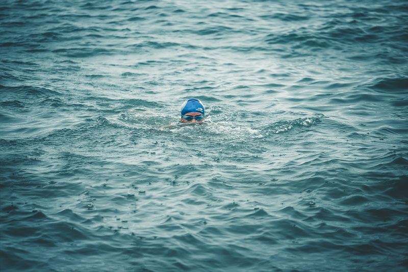 2K, waterfront, shorts, green, daytime, beauty in nature, lifejacket, bathing cap, blue, cap, outdoors, diving, vest, day, water, rippled, human, body
