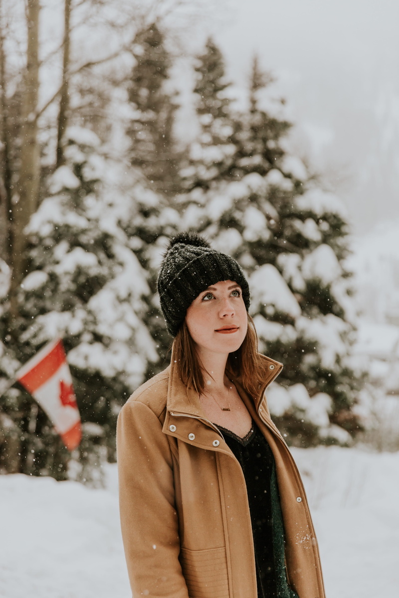 hat, place, beautiful woman, snowing, flag, extreme weather, jacket, cold temperature, canada, snow, portrait, plant, one person, lifestyles, outdoors