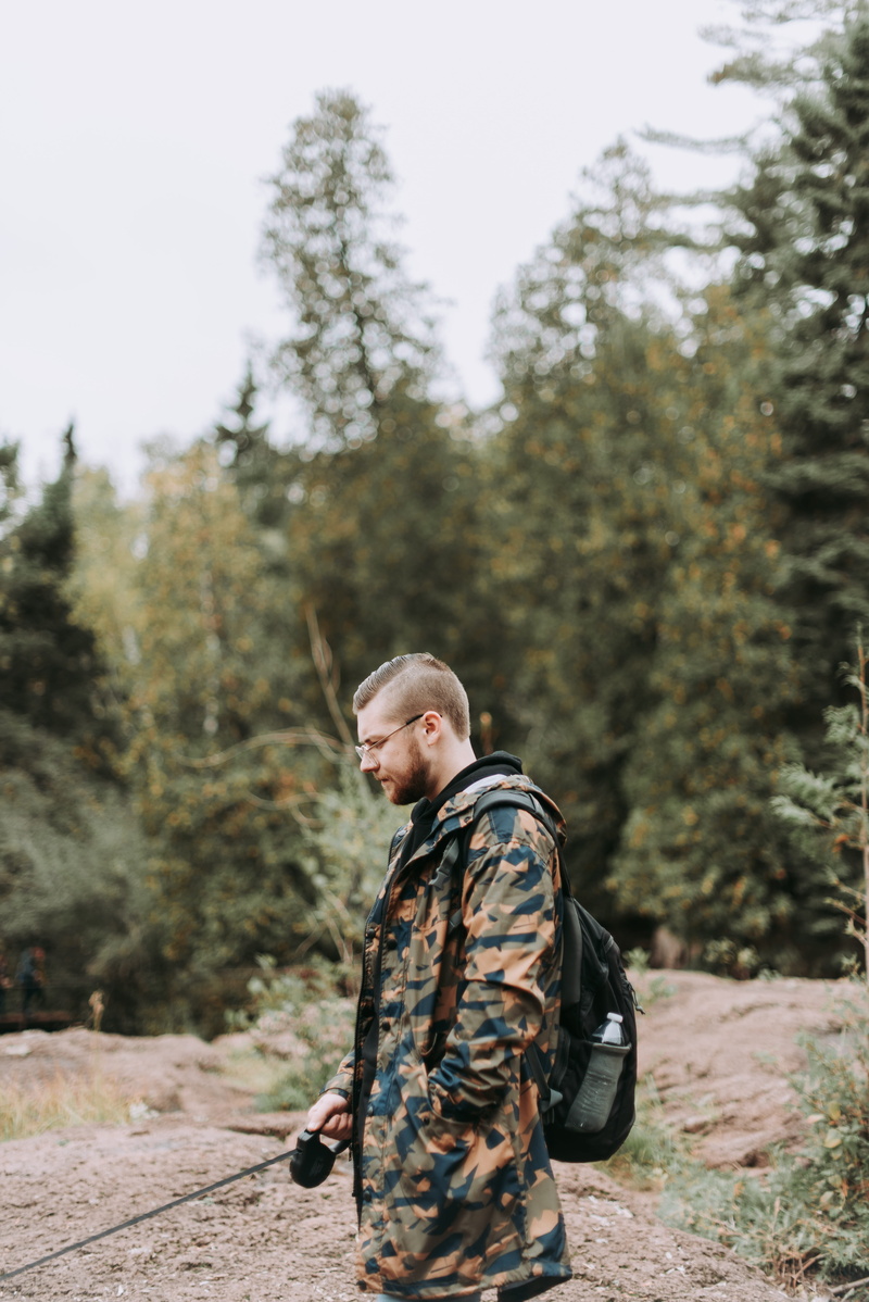 military uniform, looking, man, land, wearing, young adult, human, standing, focus on foreground, plant, leisure activities, people, casual clothing, men