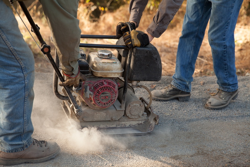 outdoors, body part, stamper, shoe, road, gas, casual clothing, motion, rubber boot, human limb, adult, men, day, workers, trail, holding, people, labor