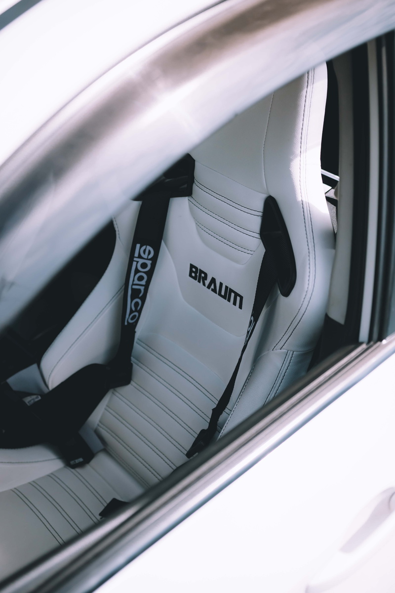 spoke, racecar, racing seat, mode of transportation, automobile, fast, white color, seatbelt, technology, car, western script, high angle view, bagged