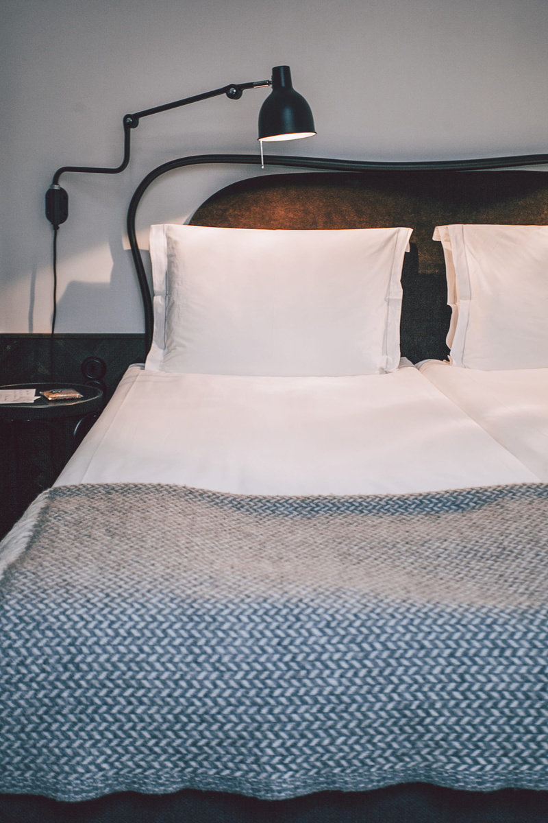 seat, day, plastic wrap, no people, textile, mattress, indoors, blanket, empty, light fixture, rug, table, cushion, black, turned, mosquito net, lampshade