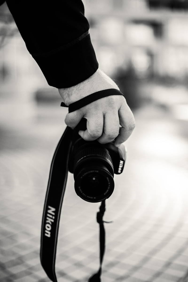person, care, adult, banister, camera lens, shelf, strap, video camera, human, close-up, hardwood, camera, human finger, nikon, photo, holding, electronics