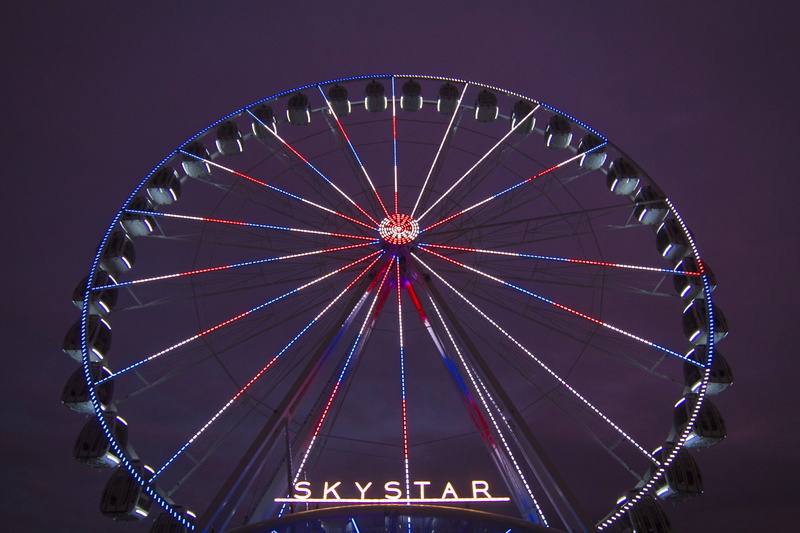 fairground, crowd, arts culture and entertainment, person, blue, illuminated, outdoors, white, red, no people, ferris wheel, machine, wheel, united states