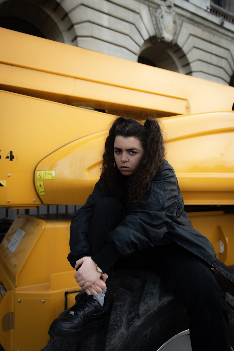 yellow, hairstyle, sitting, car, mode of transportation, automobile, 5K, one person, evening dress, warm clothing, human, young women, leather, car wheel