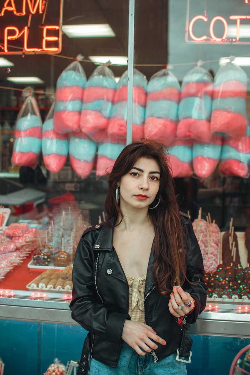 overcoat, store, black, casual clothing, purse, food, human, standing, young adult, one person, near, coat, retail, real people, beautiful woman, lifestyles
