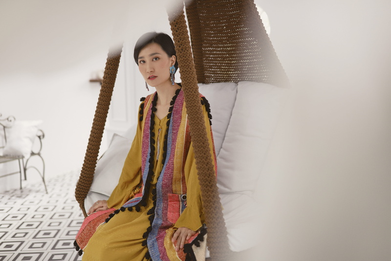 photography, person, finger, women, real people, contemplation, sleeve, white, sitting, indoors, clothing, inside, swing, face, fashion, coat, beautiful woman