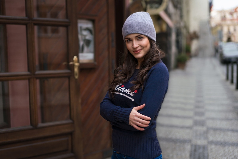 women, hairstyle, casual clothing, beautiful woman, clothing, architecture, looking at camera, adult, hat, warm clothing, urban, hair, lifestyles, focus on foreground