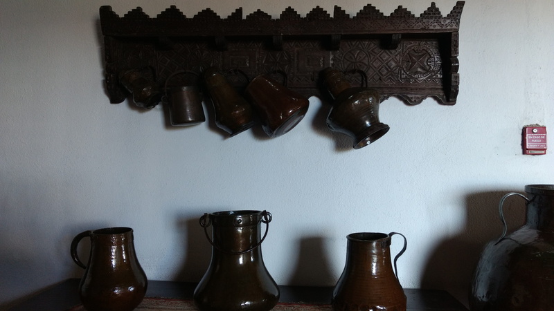 wall - building feature, bomb, furniture, cabinet, jug, still life, beverage, shelf, home interior, grenade, no people, day, musical instrument, bed, bottle